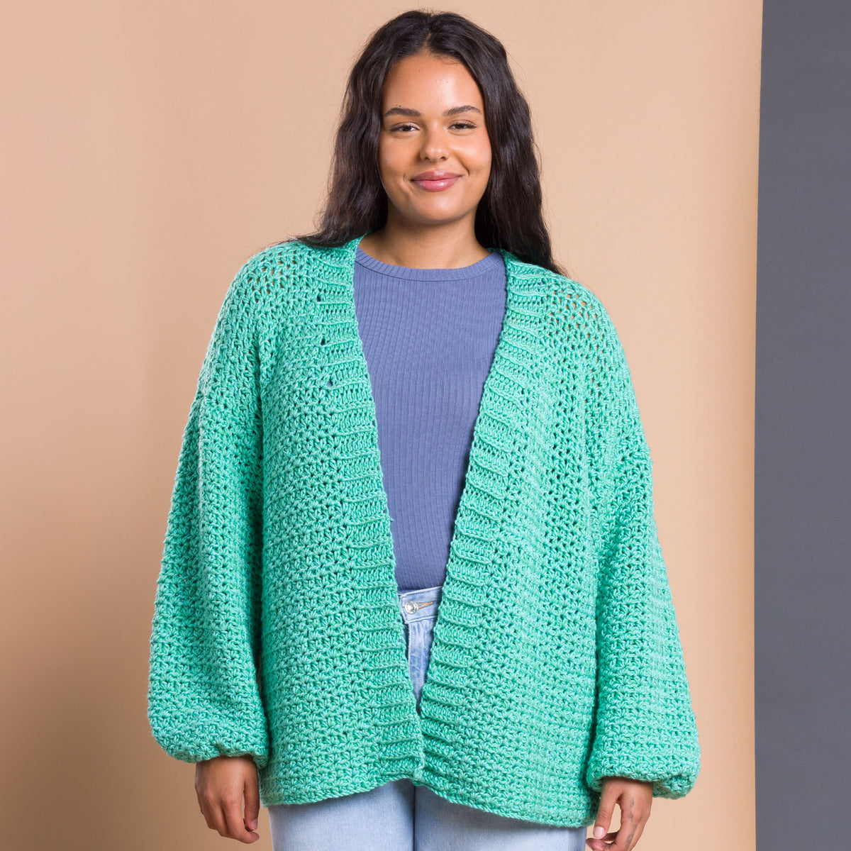 Nice And Easy Crochet Cardigan made using Caron yarn in a styled lifestyle setting