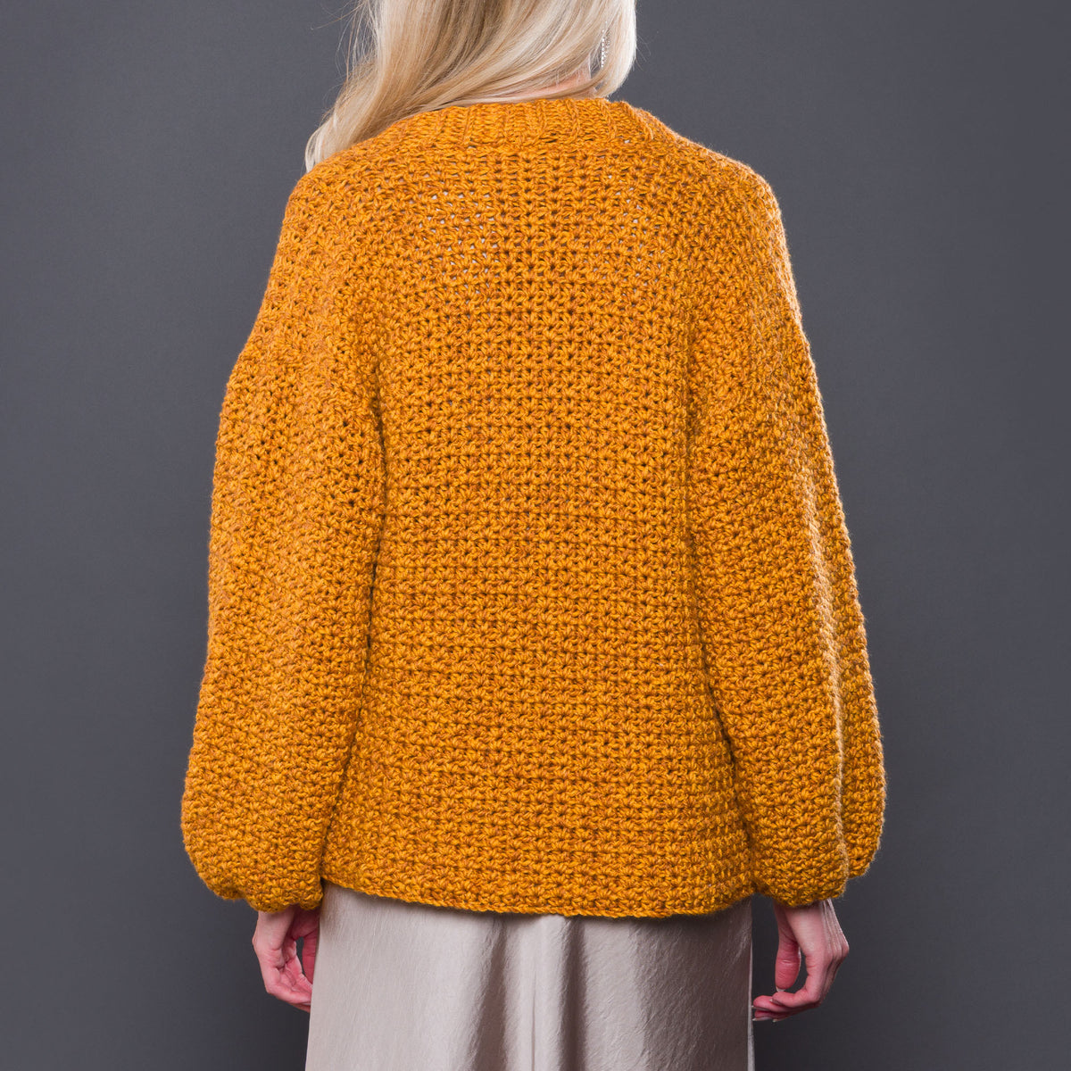 Nice And Easy Crochet Cardigan made using Caron yarn in a styled lifestyle setting