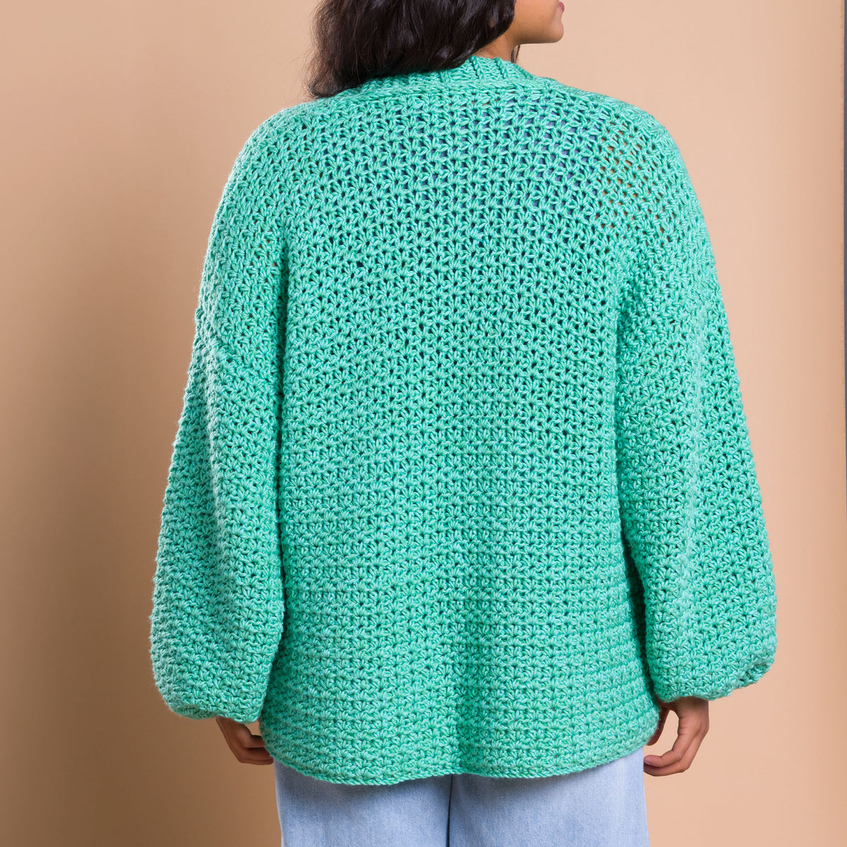 Nice And Easy Crochet Cardigan made using Caron yarn in a styled lifestyle setting