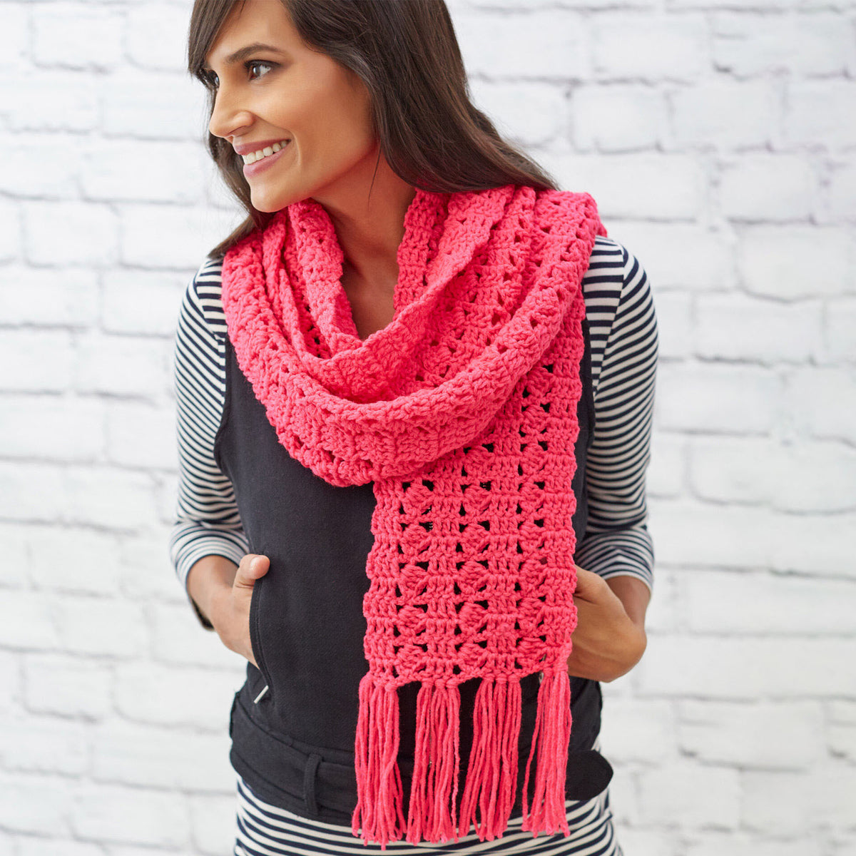 Crochet Cosmo Scarf made using Red Heart yarn in a styled lifestyle setting
