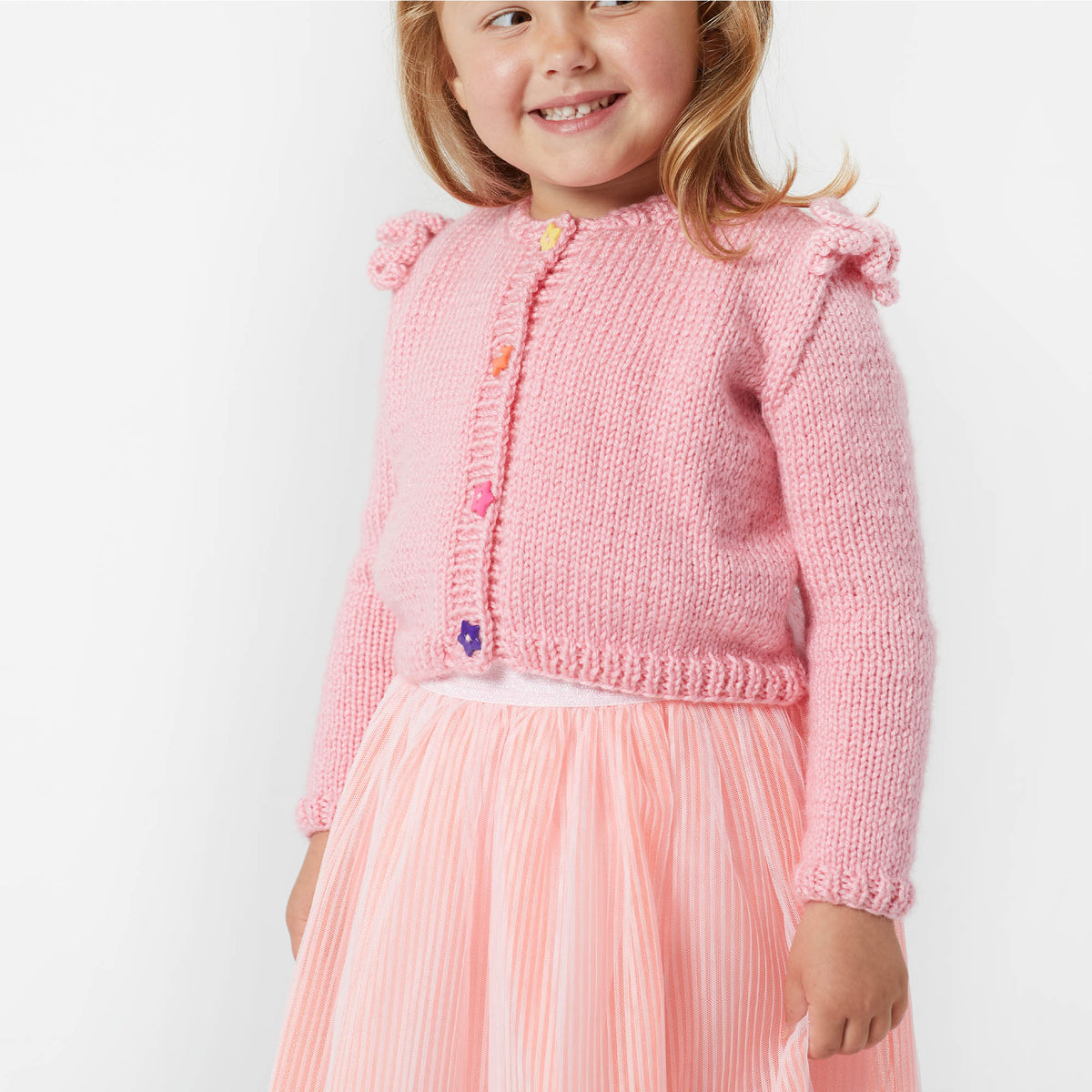 Ruffled Shoulder Knit Cardigan made using Red Heart yarn in a styled lifestyle setting