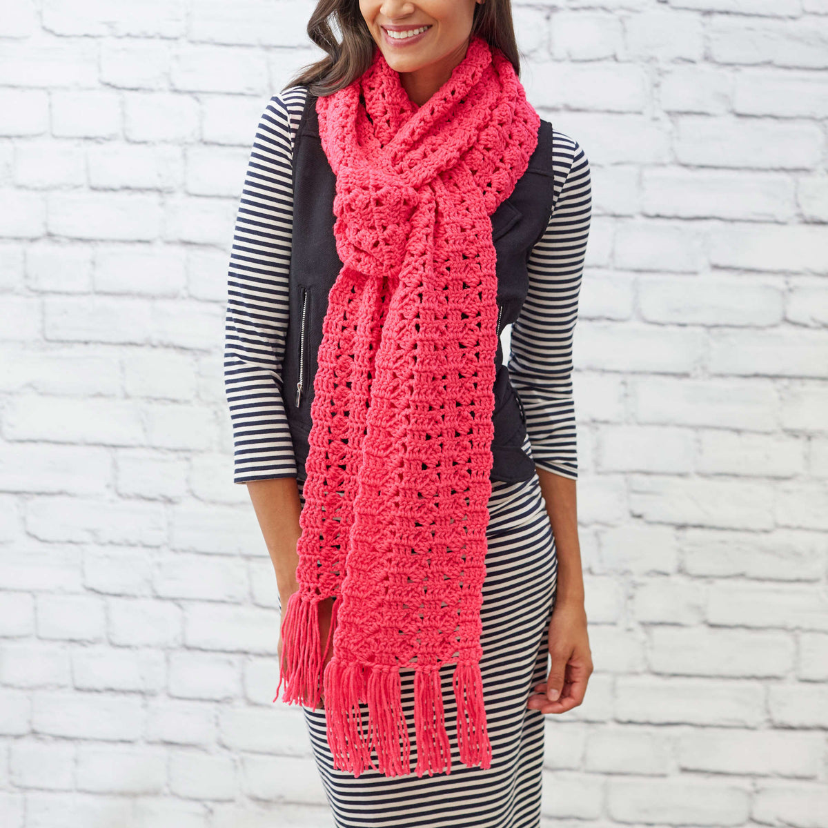 Crochet Cosmo Scarf made using Red Heart yarn in a styled lifestyle setting