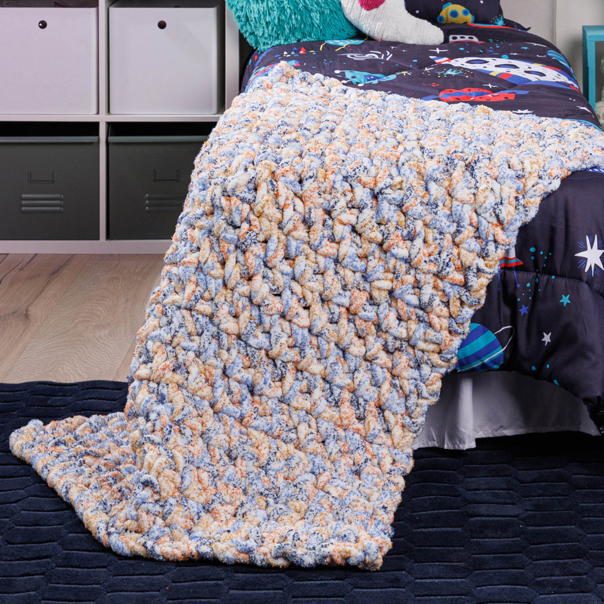 Big textured crochet blanket made using Bernat yarn.