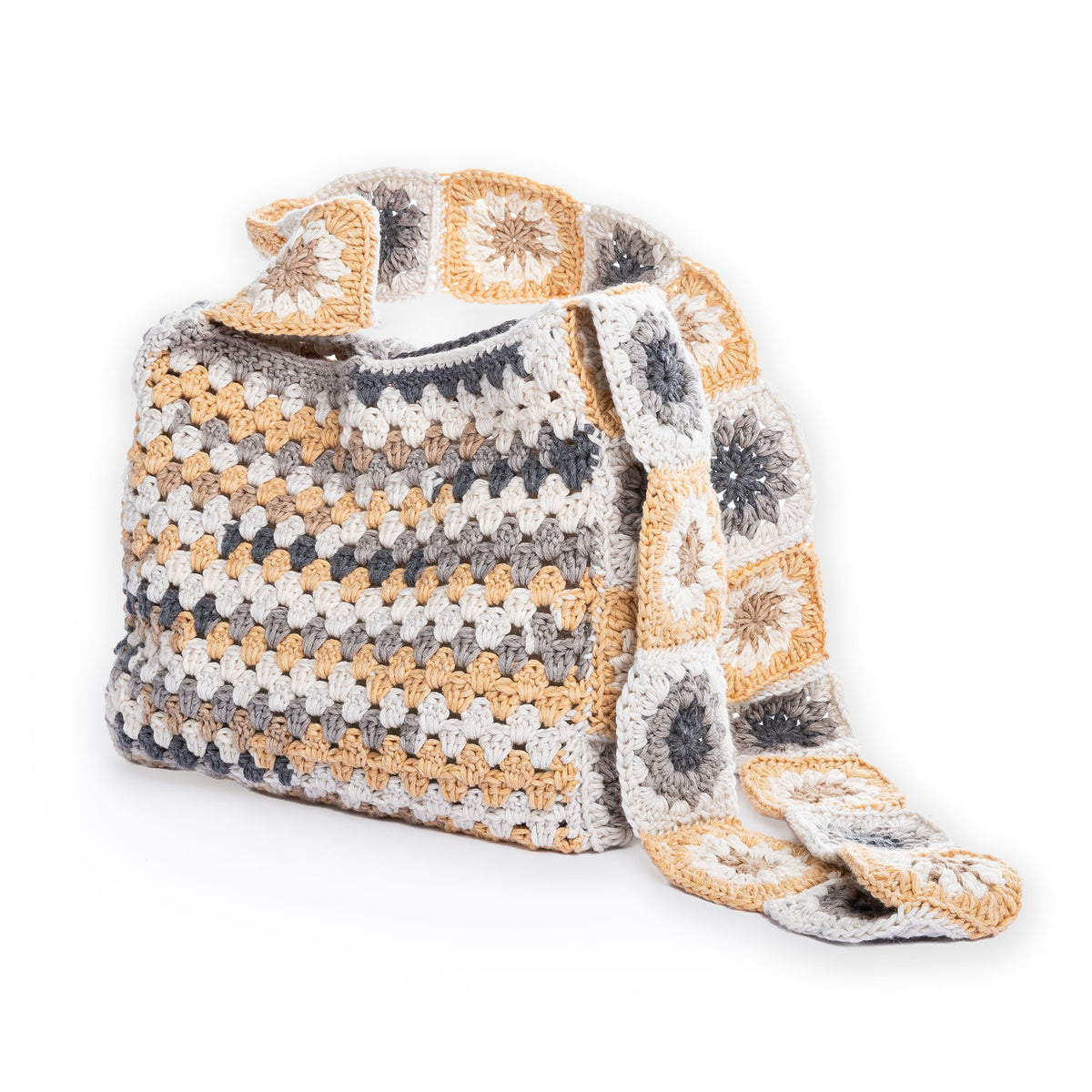 Crochet Tie Top Tote made using Caron yarn in a styled lifestyle setting