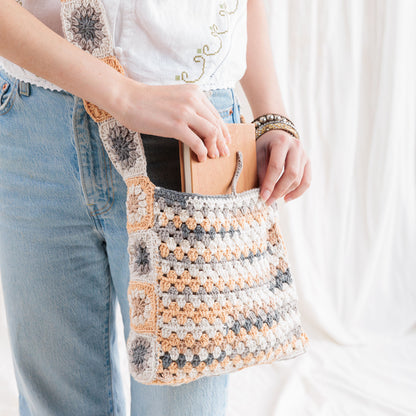 Caron Crochet Tie Top Tote Crochet Tie Top Tote made using Caron yarn in a styled lifestyle setting
