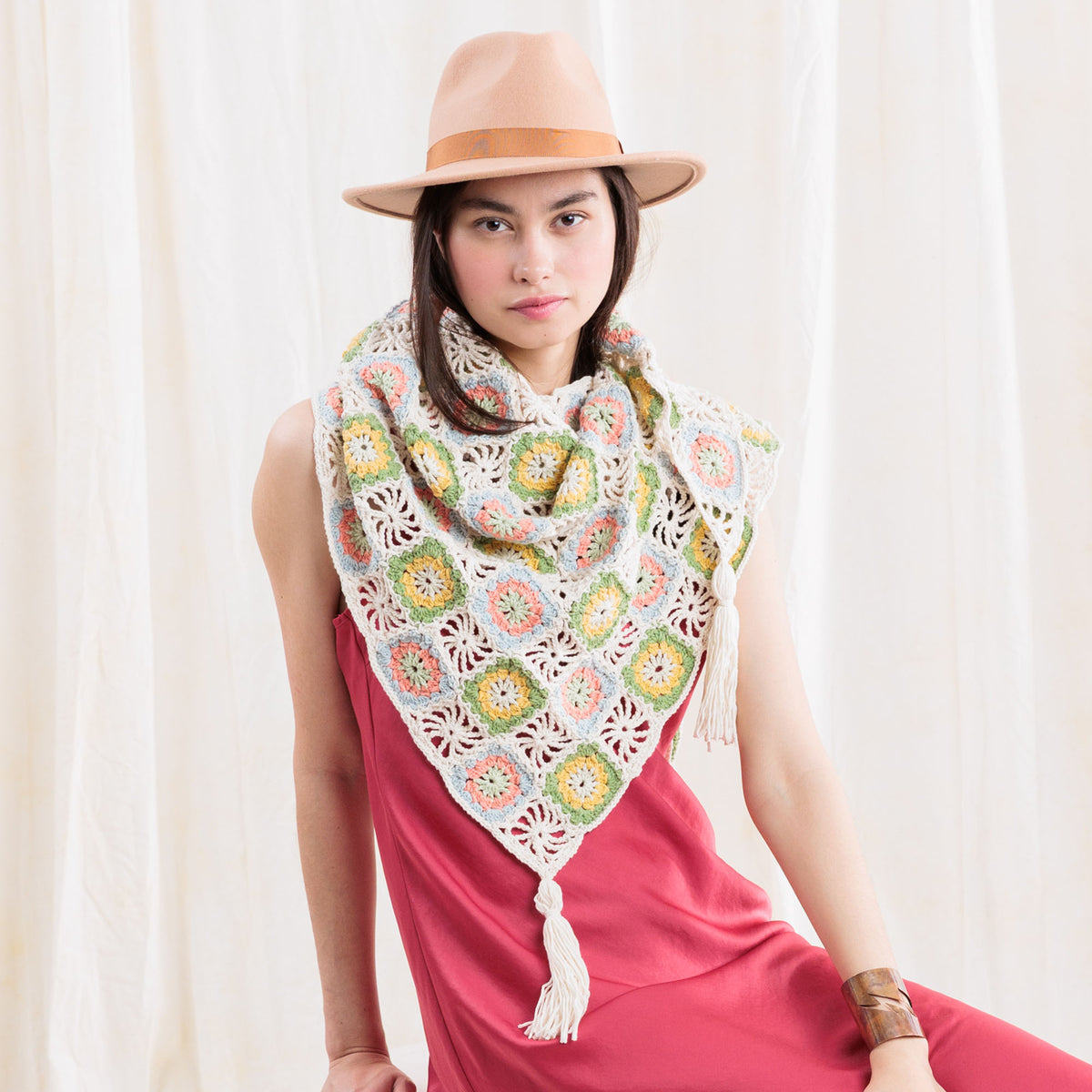 Summer Mode Crochet Triangle Shawl With Tassels made using Caron yarn in a styled lifestyle setting