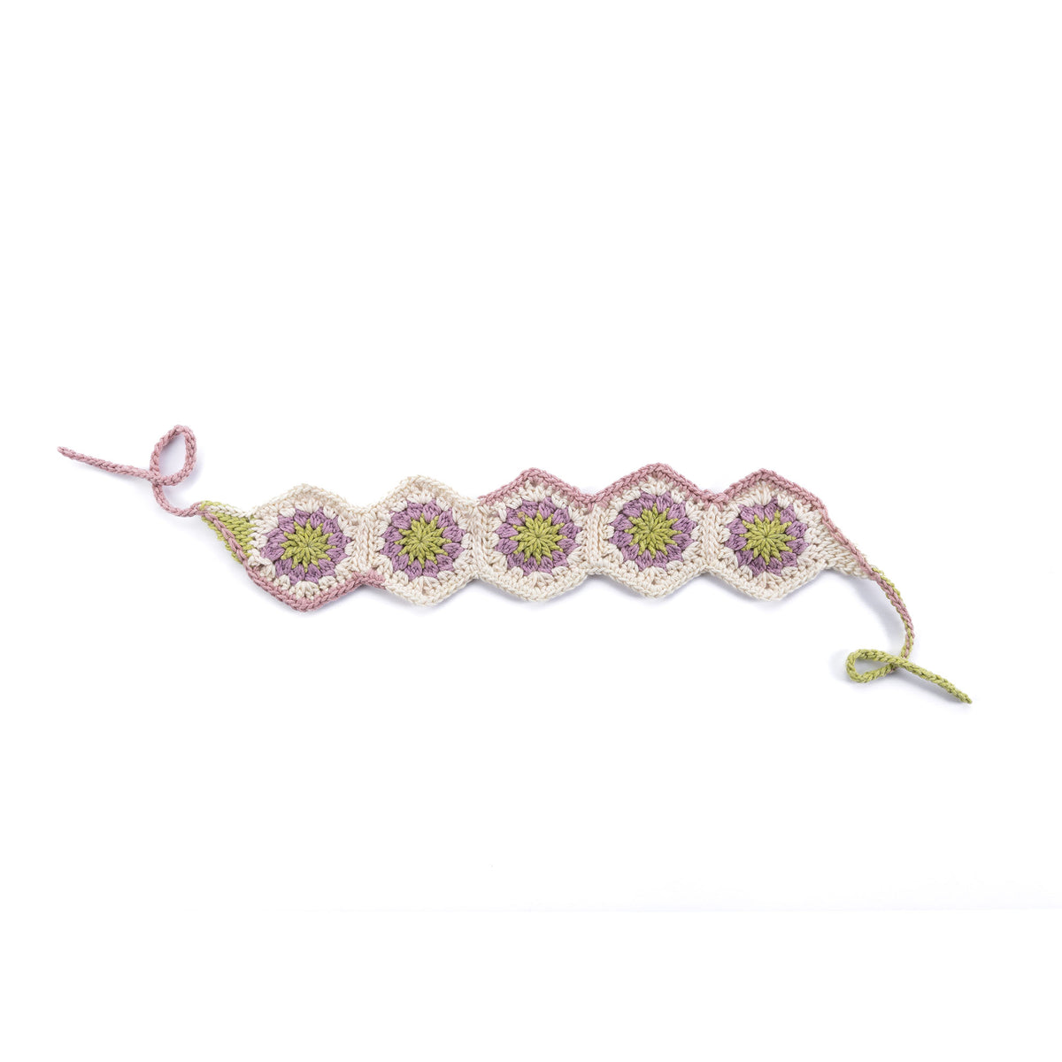 Summer Mode Crochet Headband made using Caron yarn on a white background