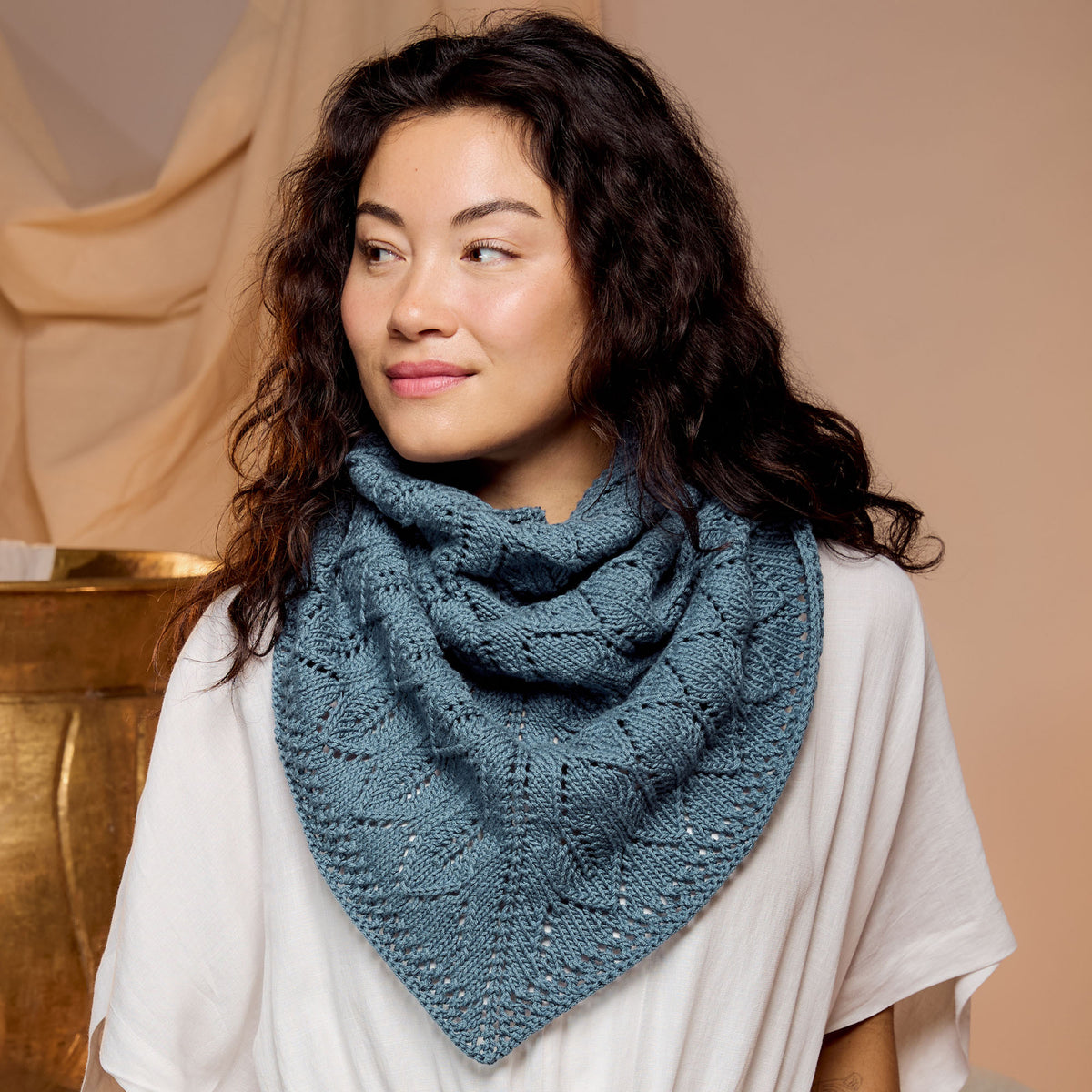 Ocean Waves Knit Shawl made using Caron yarn in a styled lifestyle setting