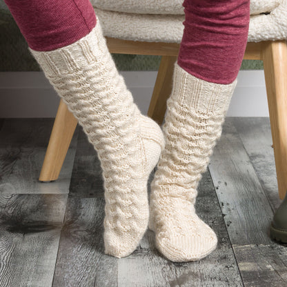 Patons Cabin Cable Knit Socks Pair of beige knitted socks using Patons yarn.