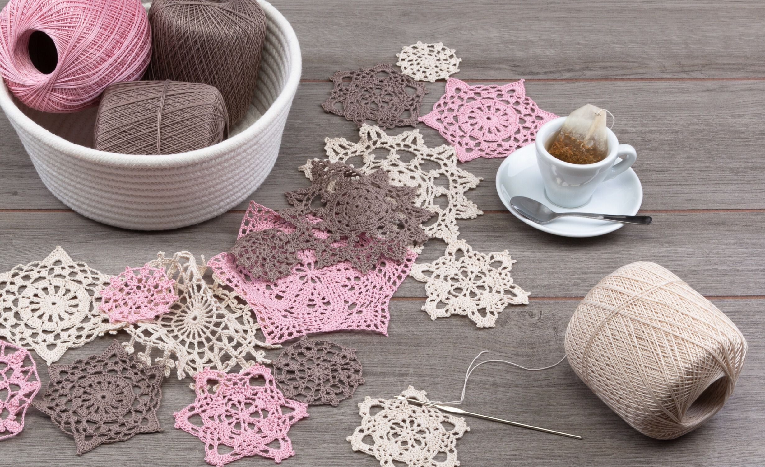 Crochet snowflakes in pink, cream, and brown