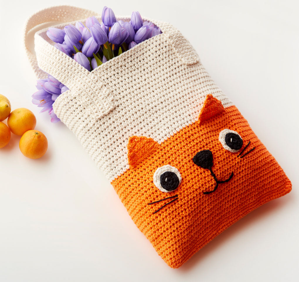 Cream crochet bag with orange cat character