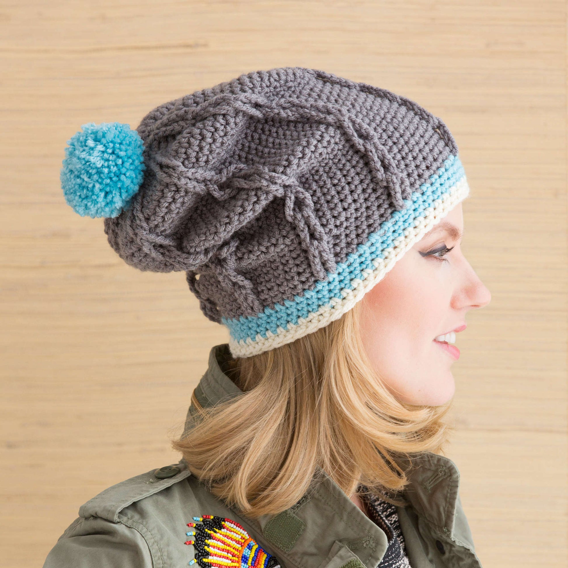 Free Red Heart Cabled Hat With Pompom Crochet Pattern